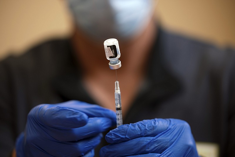 New York Times photo by Brett Carlsen / A pharmacist prepares a dose of the Pfizer COVID-19 vaccine at a clinic in Nashville on May 13.