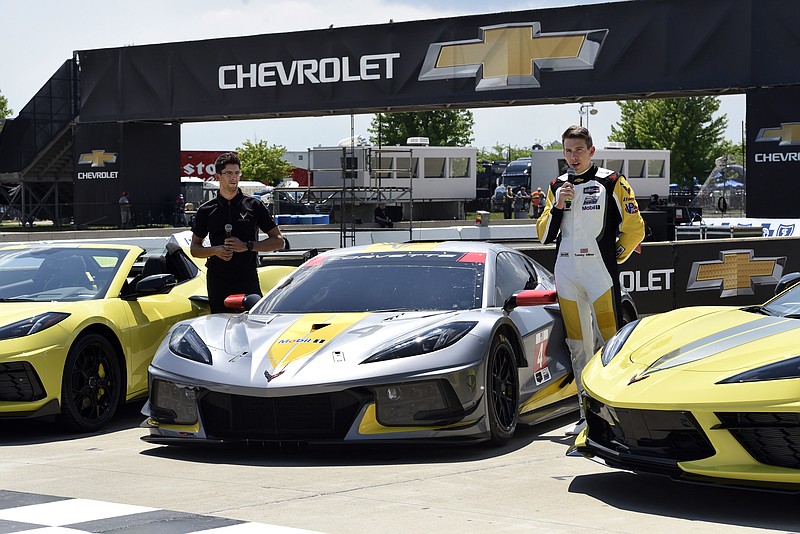 Drivers Jordan Taylor, left, and Tommy Milner attend a news conference while standing next to a Corvette C8.R race car Wednesday, June 9, 2021, at Raceway at Belle Isle in Detroit. (AP Photo/Jose Juarez)