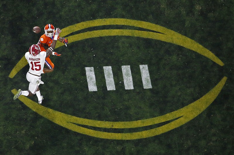 AP photo by Ross D. Franklin / Alabama's Ronnie Harrison (15) breaks up a pass intended for Clemson's Artavis Scott during the College Football Playoff title game in January 2016 in Glendale, Ariz. Alabama and Clemson each has made the four-team playoff six times in the seven years it has been held, but the bracket would multiply to 12 teams under a proposal released Thursday by the CFP.