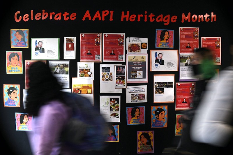 In this Monday, May 10, 2021 students walk past a display for Asian Pacific American Heritage Month at Farmington High School in Farmington, Conn. (AP Photo/Jessica Hill)


