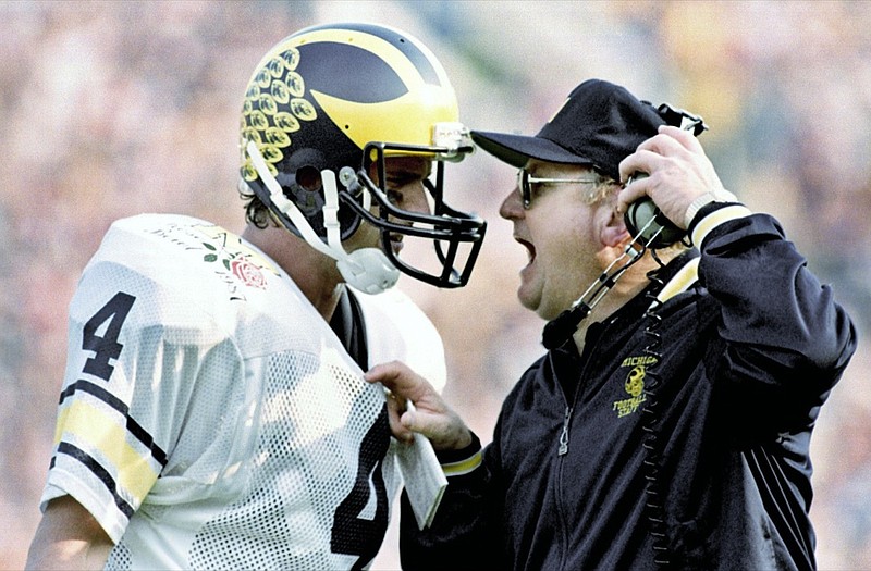 FILE - In this Jan. 2, 1987, file photo, Michigan head coach Bo Schembechler yells at quarterback Jim Harbaugh during the Rose Bowl NCAA college football game in Pasadena, Calif. A report released about the stunning lack of action at the University of Michigan while a rogue doctor, Robert Anderson, was sexually assaulting hundreds of young men has pointed an unflattering light at one of the school's giants, the late football coach Bo Schembechler, whose bronze statue stands on campus. (AP Photo/Reed Saxon, File)