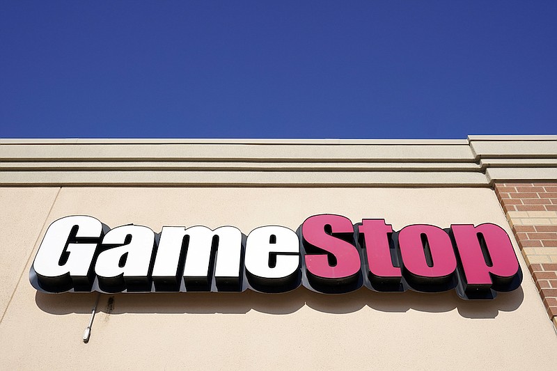 In this Jan. 28, 2021, file photo, aGameStop sign is displayed above a store in Urbandale, Iowa. GameStop and other meme stocks are soaring again. Much of professional Wall Street said earlier in the year that the phenomenon would likely fizzle out in time, particularly after the smaller-pocketed and novice investors behind it felt the pain of losing their money. But GameStop has recovered most of its plunge from its January peak. (AP Photo/Charlie Neibergall, File)