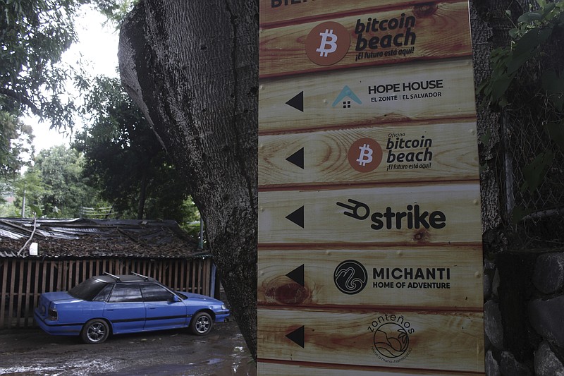 A sign that advertises the acceptance of cryptocurrencies at local businesses stands at one of the entrances of Zonte Beach in Tamanique, El Salvador, Wednesday, June 9, 2021. El Salvador's Legislative Assembly has approved legislation making the cryptocurrency Bitcoin legal tender in the country, the first nation to do so, just days after President Nayib Bukele made the proposal at a Bitcoin conference. (AP Photo/Salvador Melendez)