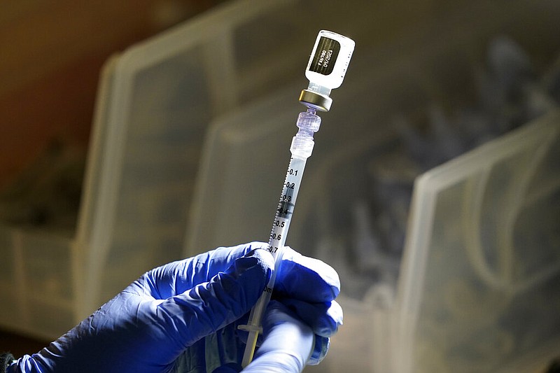 In this June 3, 2021 file photo, a Pfizer vaccine is prepared at a COVID-19 vaccination clinic at PeaceHealth St. Joseph Medical Center in Bellingham, Wash. On Friday, June 11, The Associated Press reported on stories circulating online incorrectly claiming COVID-19 vaccines make people produce a spike protein that is a toxin and can spread to other parts of the body and damage organs. (AP Photo/Elaine Thompson)