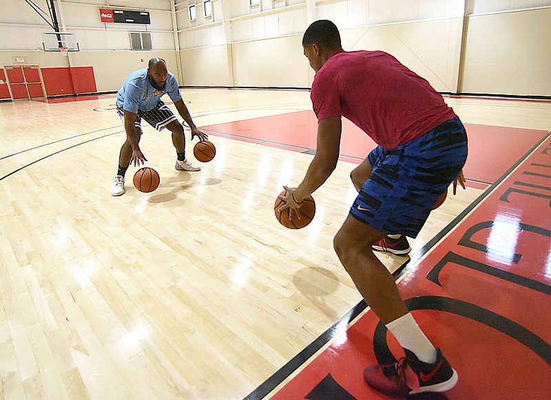 Staff photo by Matt Hamilton / Trey Suttles, left, runs a dribbling drill with Todd Landsden on Wednesday at Antioch Missionary Baptist Church.