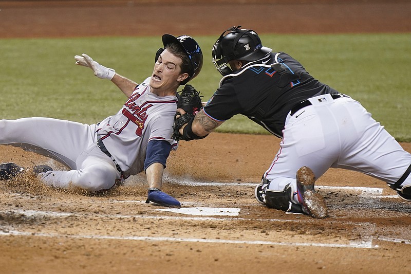 AP photo by Wilfredo Lee / Miami Marlins catcher Sandy Leon tags out Atlanta Braves pitcher Max Fried at home plate during the third inning of Saturday's game in Miami. The Marlins won 4-2 as Atlanta's losing streak reached four games.