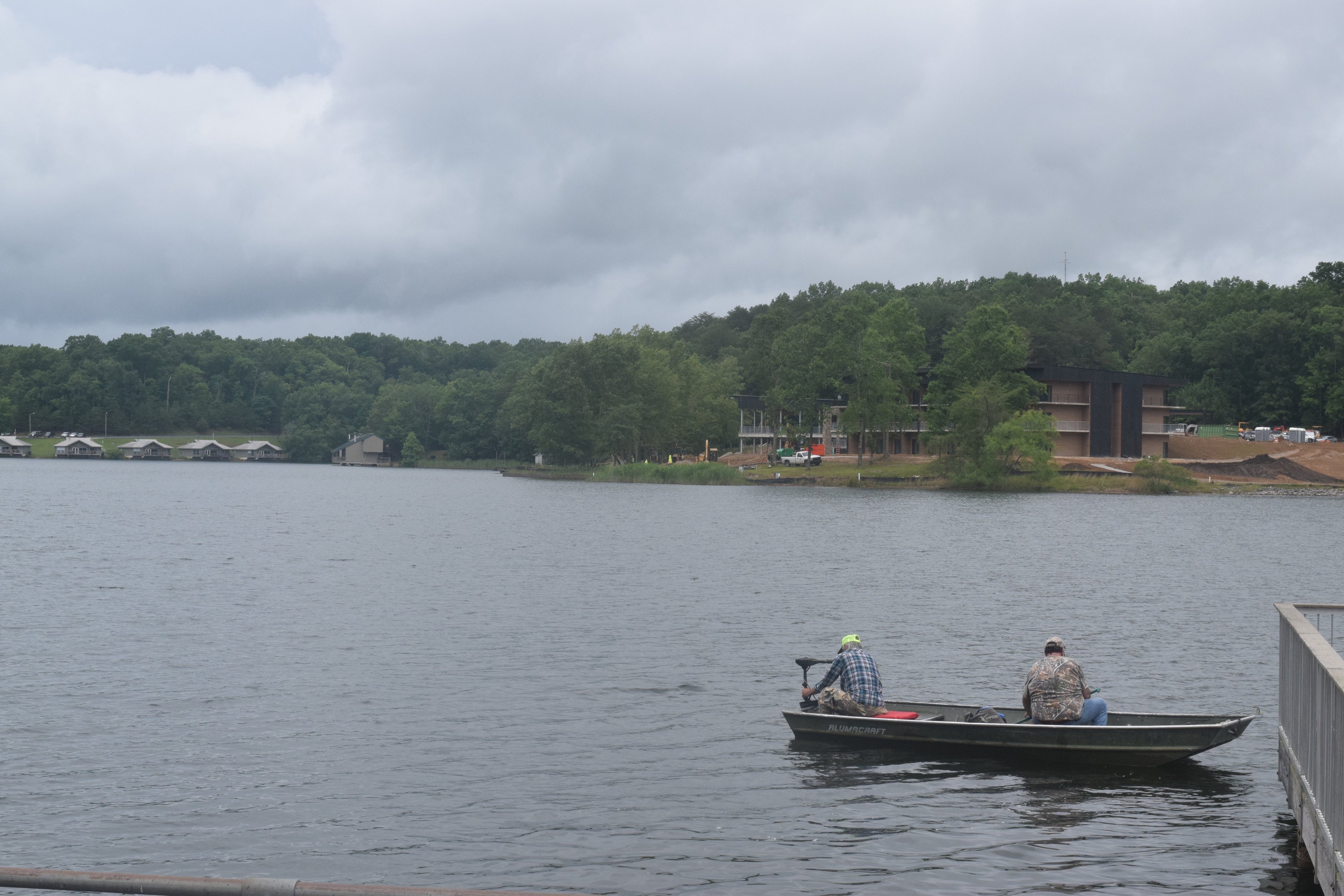 Staff photo by Ben Benton / Local anglers Anthony Walker, at the stern, and Sonny Davis, both from Van Buren County, Tenn., take a rented boat out on Falls Creek Falls Lake Wednesday, June 9, 2021, where the new $40.4 million Fall Creek Falls Lodge is taking shape at Fall Creek Falls State Park. State officials say the lodge will be completed by the end of the year. #