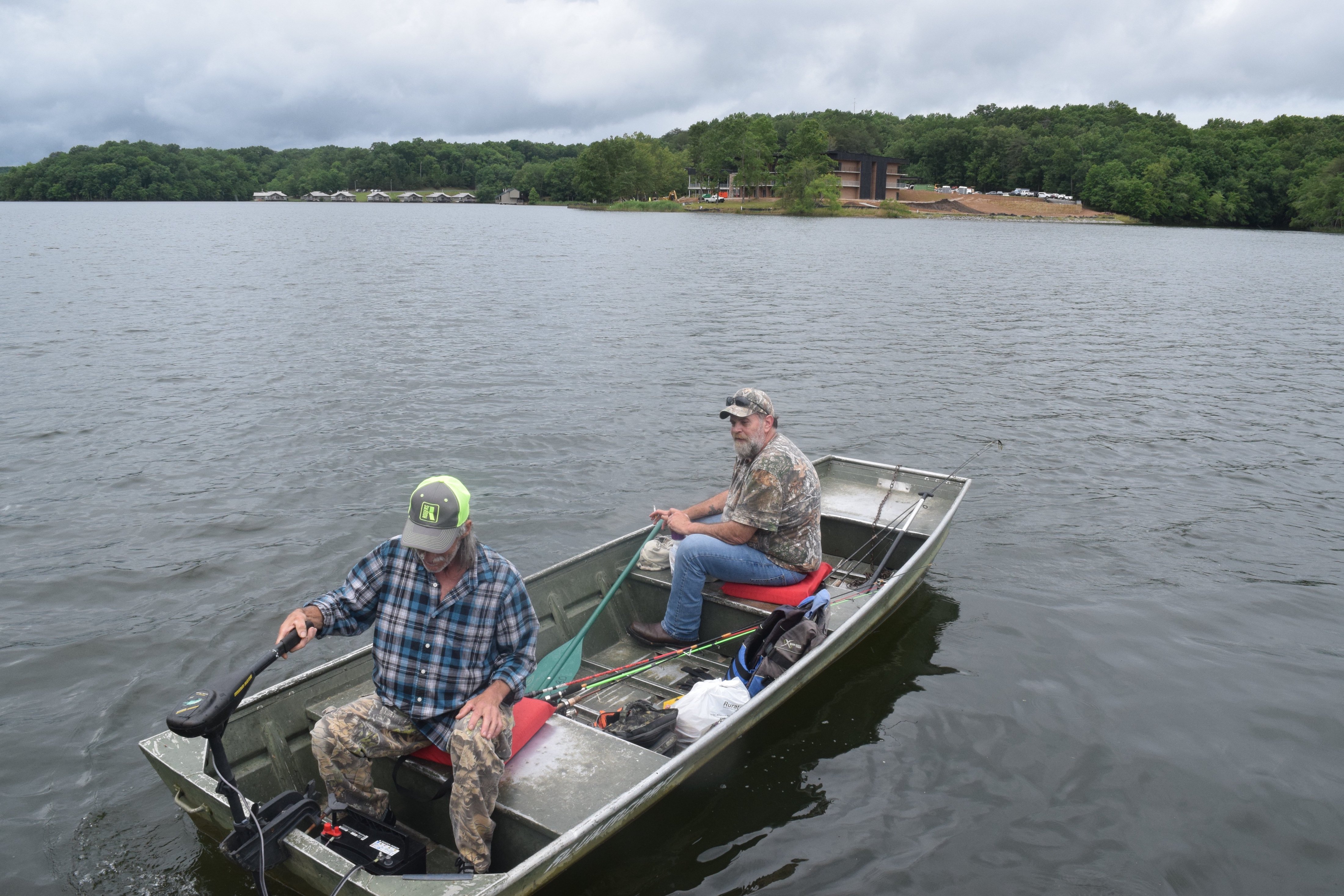 Staff photo by Ben Benton / Local anglers Anthony Walker, at the stern, and Sonny Davis, both from Van Buren County, Tenn., take a rented boat out on Falls Creek Falls Lake Wednesday, June 9, 2021, where the new $40.4 million Fall Creek Falls Lodge is taking shape at Fall Creek Falls State Park. State officials say the lodge will be completed by the end of the year.