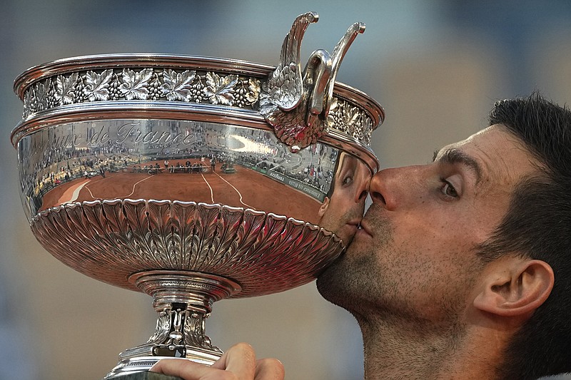 AP photo by Michel Euler / Novak Djokovic kisses his trophy after beating Stefanos Tsitsipas to win the French Open on Sunday. Djokovic won 6-7 (6), 2-6, 6-3, 6-2, 6-4.