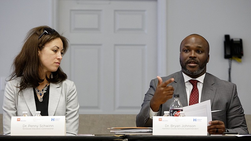 Staff photo by C.B. Schmelter / Tennessee Education Commissioner Penny Schwinn, left, looks on as Superintendent Bryan Johnson speaks during a Partnership Network Advisory board meeting at the Hamilton County Department of Education board room on Tuesday, Sept. 17, 2019 in Chattanooga, Tenn.