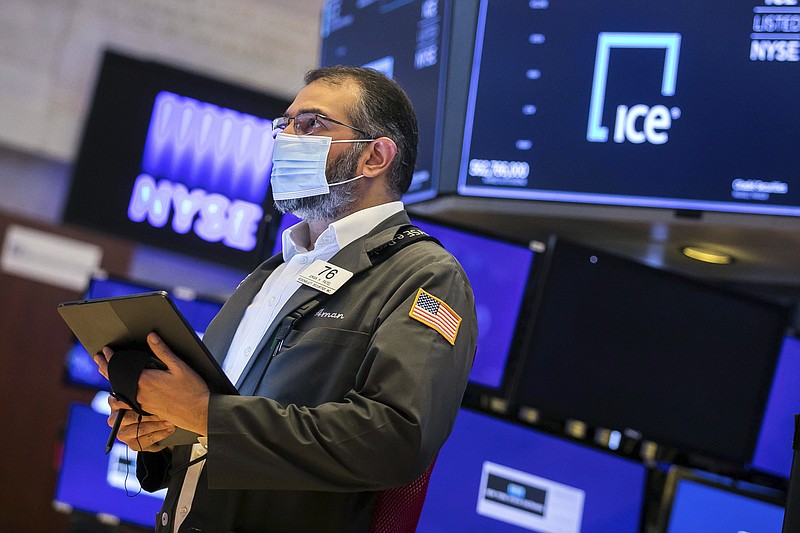 In this photo provided by the New York Stock Exchange, trader Aman Patel works on the floor of the NYSE, Monday, June 14, 2021. Stocks fell on Wall Street Monday in a sluggish start to the week as investors await the latest take from the Federal Reserve on inflation. (Courtney Crow/New York Stock Exchange via AP)
