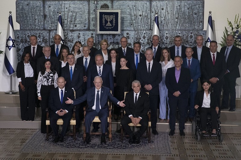 Israeli Prime Minister Naftali Bennett, seated left, President Reuven Rivlin, seated center, and Alternate Prime Minister and Minister of Foreign Affairs Yair Lapid seated right, pose for a group photo with the ministers of the new government at the President's residence in Jerusalem, Monday, June 14, 2021. (AP Photo/Maya Alleruzzo)

