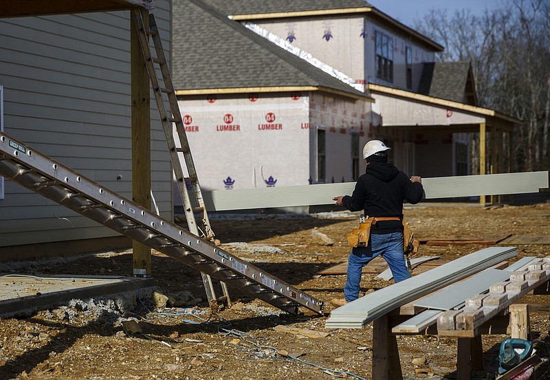 Staff file photo / A worker adds siding to a home under construction in the fast-growing eastern part of Hamilton County.