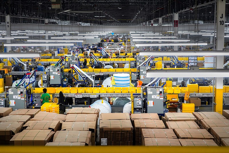 A workers in the packing area at Amazon's warehouse on Staten Island, called JFK8, on March 2, 2021. Each year, hundreds of thousands of Amazon workers churn through a vast mechanism that hires and monitors, disciplines and fires.  (Chang W. Lee/The New York Times)