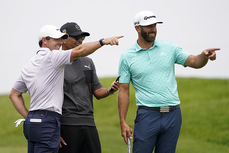 AP photo by Jae C. Hong / Four-time major winner Rory McIlroy, left, and top-ranked Dustin Johnson, right, point from the second tee box of Torrey Pines' South Course during a practice round Wednesday. Torrey Pines, an annual PGA Tour stop, is hosting the U.S. Open for the second time, with Tiger Woods having won a classic at the San Diego course in 2008.