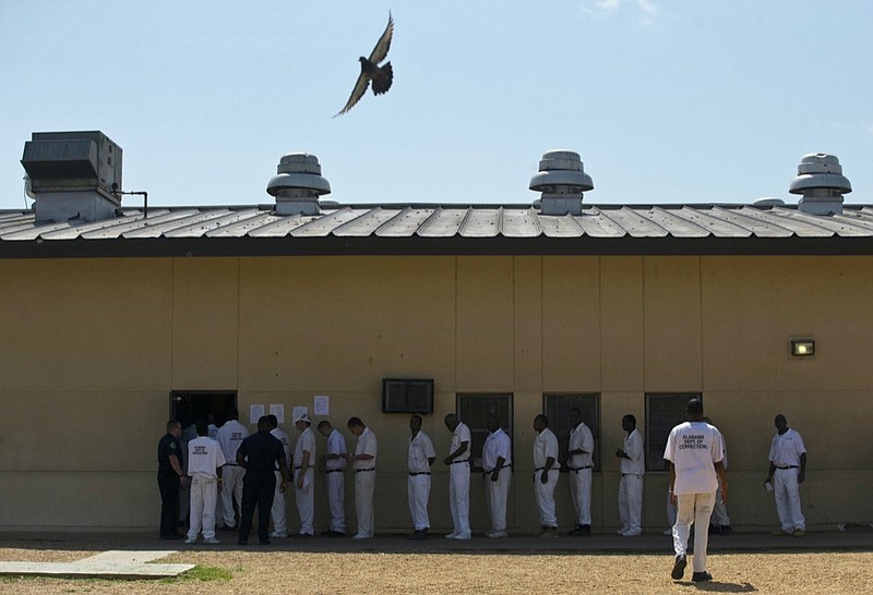 FILE - In this June 18, 2015, file photo, prisoners stand in a crowded lunch line during a prison tour at Elmore Correctional Facility in Elmore, Ala. (AP Photo/Brynn Anderson, File)


