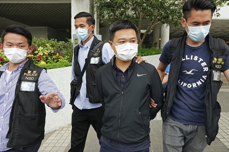 Ryan Law, second from right, Apple Daily's chief editor, is arrested by police officers in Hong Kong Thursday, June 17, 2021. (AP Photo)



