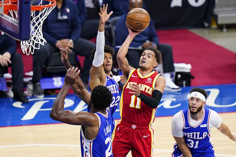 AP photo by Matt Slocum / Atlanta Hawks point guard Trae Young drives to the basket against the Philadelphia 76ers' Joel Embiid, left, Matisse Thybulle (22) and Seth Curry during the second half of their playoff game Wednesday, June 16, 2021, in Philadelphia.