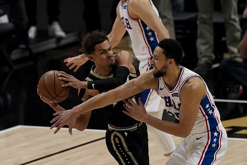 AP photo by John Bazemore / Atlanta Hawks guard Trae Young, with ball, is guarded by the Philadelphia 76ers' Ben Simmons during Friday night's game in Atlanta.