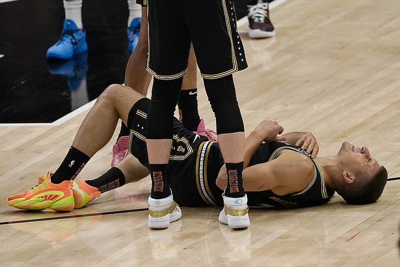 AP photo by John Bazemore / Atlanta Hawks guard Bogdan Bogdanovic remains on the court after injuring his right knee during the first half of Friday night's home game against the Philadelphia 76ers. His status for Game 7 of their Eastern Conference semifinal series Sunday night in Philadelphia was uncertain as of Saturday afternoon.