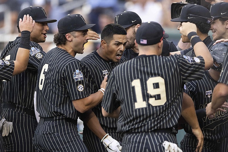 AP photo by Rebecca S. Gratz / Vanderbilt's Jayson Gonzalez, center, celebrates with teammates as he returns to the dugout after hitting a two-run homer against Arizona in the fifth inning of a College World Series game Saturday in Omaha, Neb.