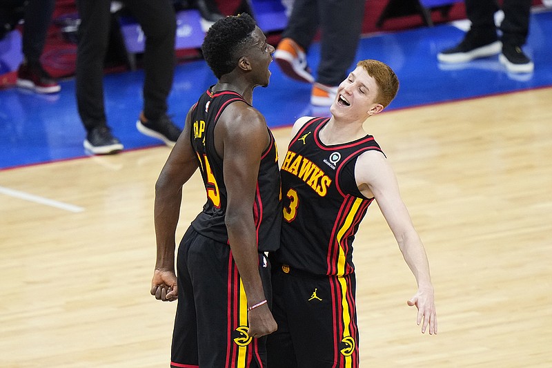 AP photo by Matt Slocum / The Atlanta Hawks' Kevin Huerter, right, and Clint Capela celebrate during the final seconds of the team's Game 7 win against the host Philadelphia 76ers on Sunday night.