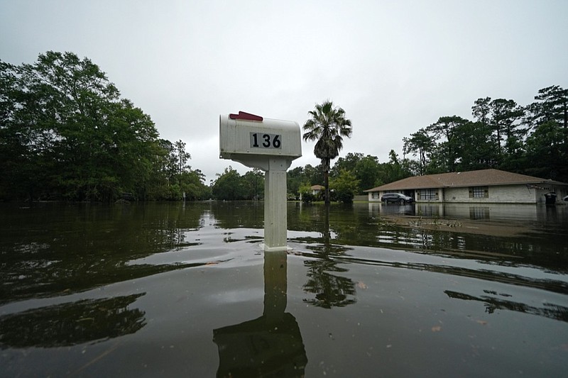 A flooded neighborhood is seen after Tropical Storm Claudette passed through in Slidell, La., Saturday, June 19, 2021. The National Hurricane Center declared Claudette organized enough to qualify as a named storm early Saturday, well after the storm's center of circulation had come ashore southwest of New Orleans. (AP Photo/Gerald Herbert)