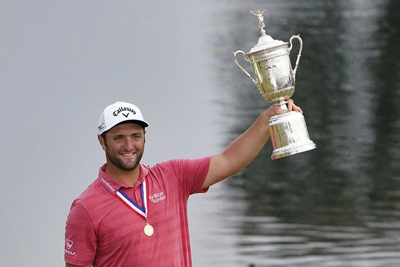 Jon Rahm, of Spain, holds the champions trophy for photographers after the final round of the U.S. Open Golf Championship, Sunday, June 20, 2021, at Torrey Pines Golf Course in San Diego. (AP Photo/Jae C. Hong)