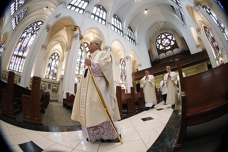 Photo by David Zalubowski of The Associated Press / Denver Archbishop Samuel J. Aquila enters the Cathedral Basilica of the Immaculate Conception to deliver Easter Mass during a broadcast of services in Denver. "There is danger to one's soul if he or she receives the body and blood of our Lord in an unworthy manner," says Aquila, targeting his warning at "those in prominent positions who reject fundamental teachings of the Church and insist that they be allowed to receive Communion."