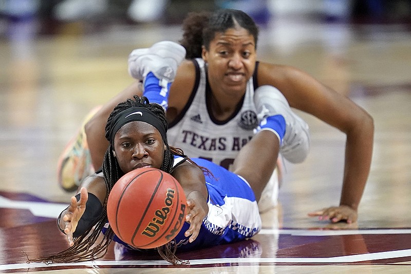 AP photo by Sam Craft / Kentucky's Rhyne Howard reaches for a loose ball ahead of Texas A&M center Ciera Johnson on Jan. 7 in College Station, Texas.