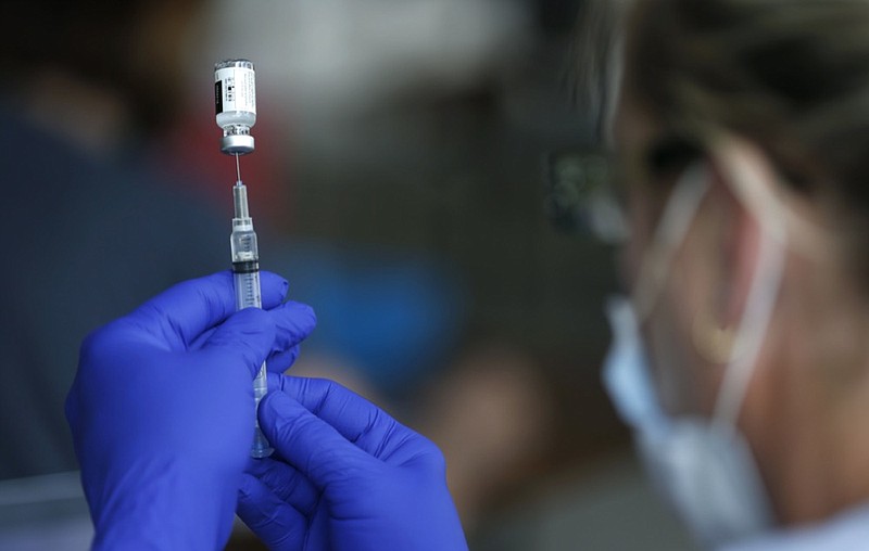 Nurse Jody Berry draws a syringe full of the Johnson & Johnson COVID-19 vaccine at a clinic at Mother's Brewing Company in Springfield, Mo., on Tuesday, June 22, 2021. (Nathan Papes/The Springfield News-Leader via AP)

