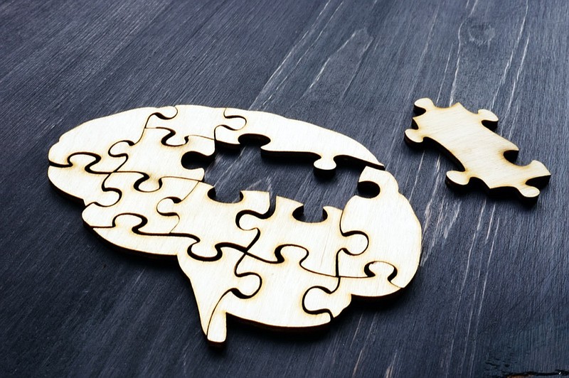 Brain from wooden puzzles. Mental Health and problems with memory. brain tile dementia health tile / Getty Images
