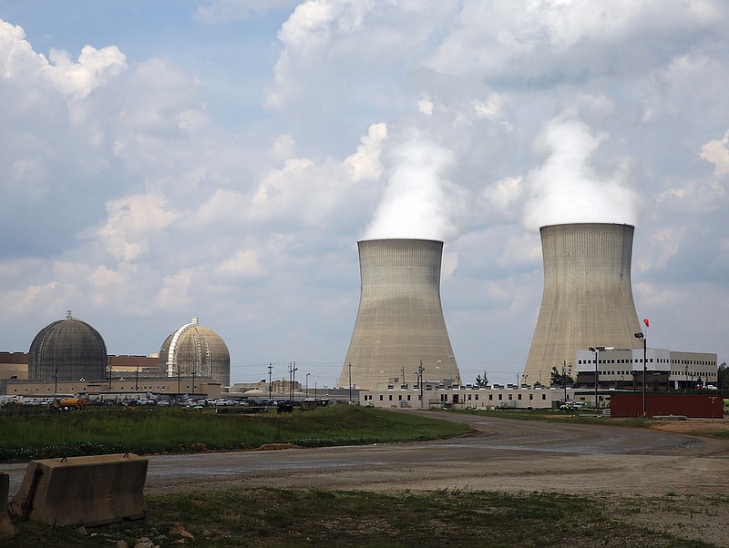 The cooling towers, right, and nuclear reactor containment buildings, left, at Plant Vogtle Nuclear Power Plant are shown in Waynesboro, Ga. (AP Photo/John Bazemore)