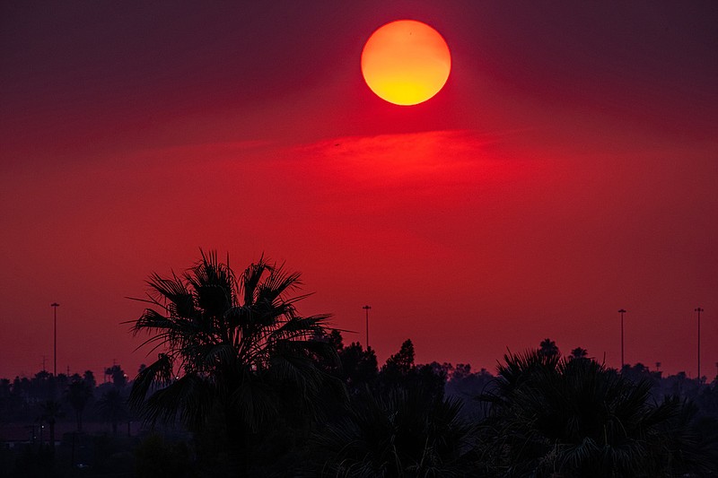 New York Times photo by Ash Ponders / The sunset over Phoenix, Ariz., tinted by smoke from nearby wildfires on Tuesday, June 15, when temperatures climbed to 118 degrees. Much of the West is suffering from unusually scorching temperatures under a large and persistent heat dome and drought.