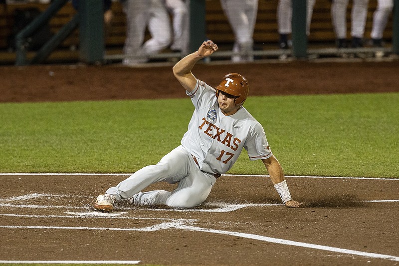 AP photo by John Peterson / Ivan Melendez scores a run for Texas during the second inning of a College World Series game against Virginia on Thursday night in Omaha, Neb.