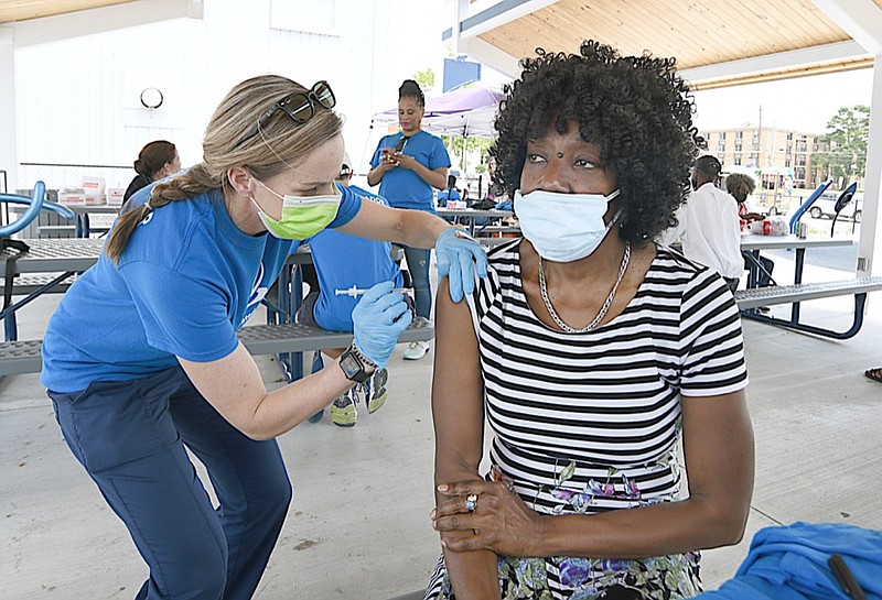 Staff Photo by Matt Hamilton / Nurse Holly Monroe, left, vaccinates Beverly Jones of Chattanooga during a block party at the BlueCross Healthy Place at Highland Park in Chattanooga on Saturday, June 26, 2021.
