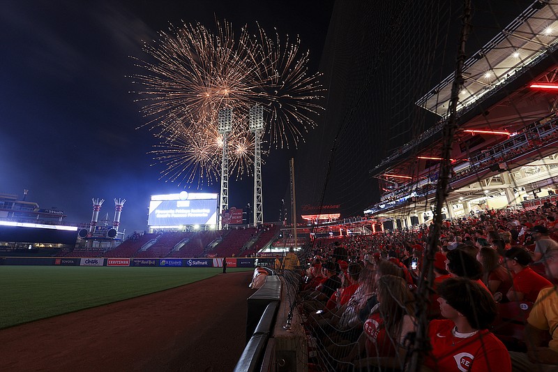 AP photo by Aaron Doster / Baseball fans watch the fireworks after Friday night's game between the Atlanta Braves and the host Cincinnati Reds.