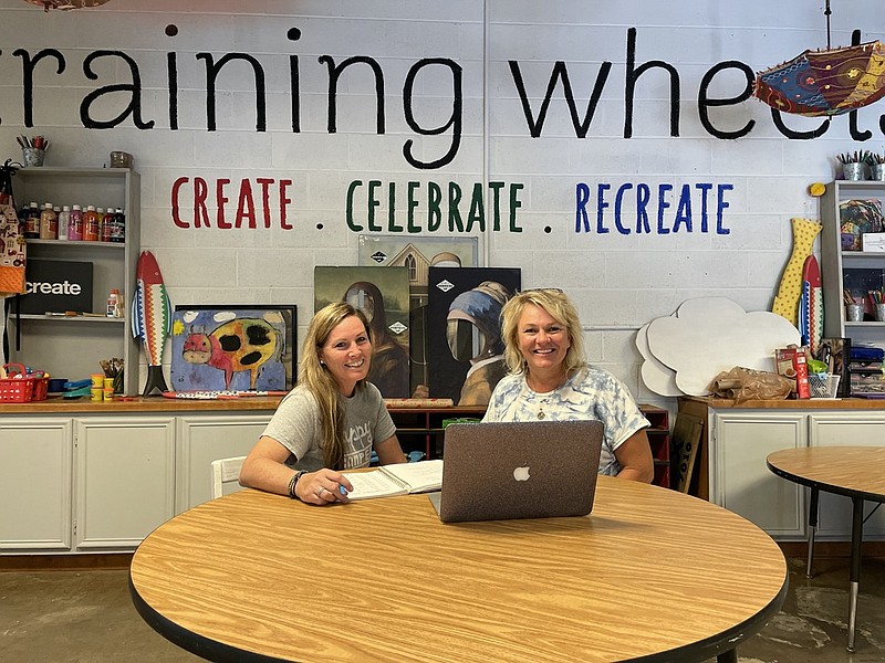 Staff photo by Mark Kennedy / Theresa Nix, left, and Kim Leffew prepare for the opening of Training Wheels, a center for special needs children and their families on East 11th Street. Nix is CEO of the nonprofit Downside Up, while Leffew is the board chair. 