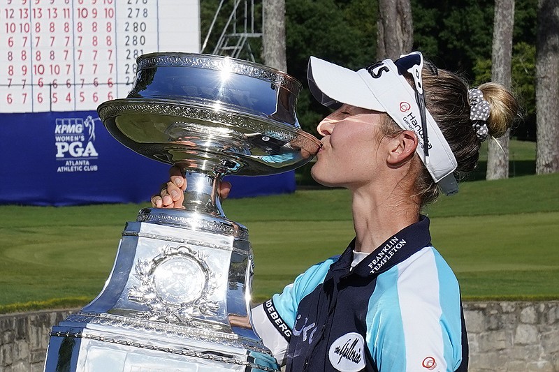 AP photo by John Bazemore / Nelly Korda kisses the trophy after winning the KPMG Women's PGA Championship on Sunday in Johns Creek, Ga.