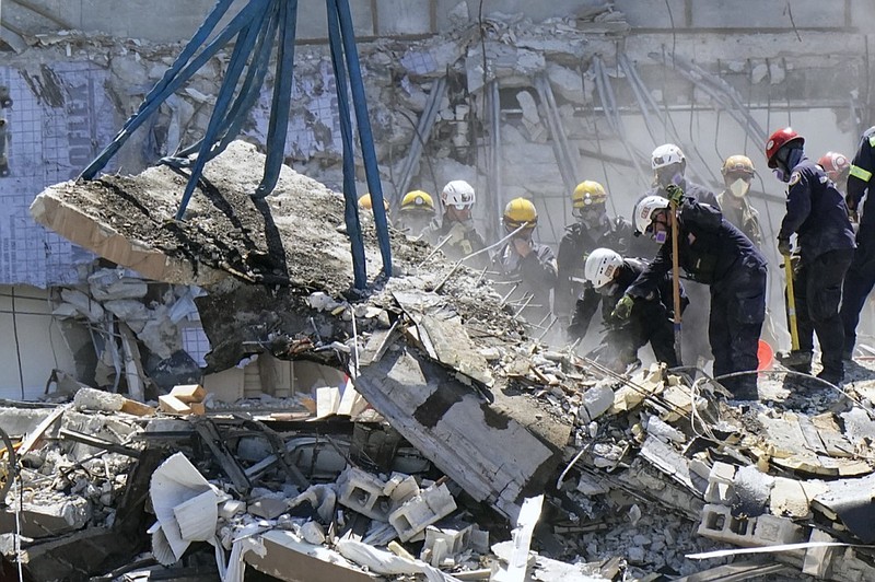 Crews work in the rubble at the Champlain Towers South Condo, Sunday, June 27, 2021, in Surfside, Fla. Many people were still unaccounted for after Thursday's fatal collapse. (AP Photo/Wilfredo Lee)