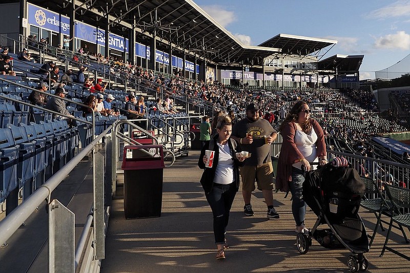 Staff File Photo By C.B. Schmelter / Fans make their way to their seats during a game between the Chattanooga Lookouts and the Rocket City Trash Pandas at AT&T Field last month.