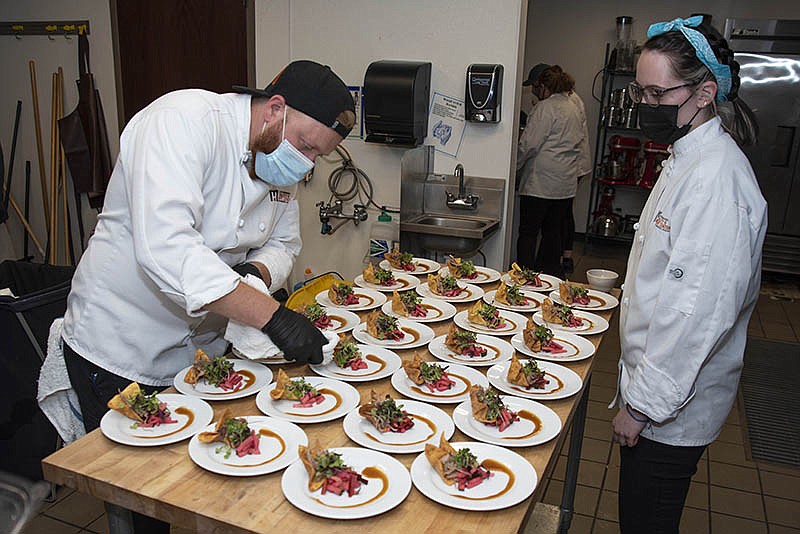 Photo by Michael Hampton / Mac McGuire and Ansleigh Gitgood prepare the first dish of the eveni