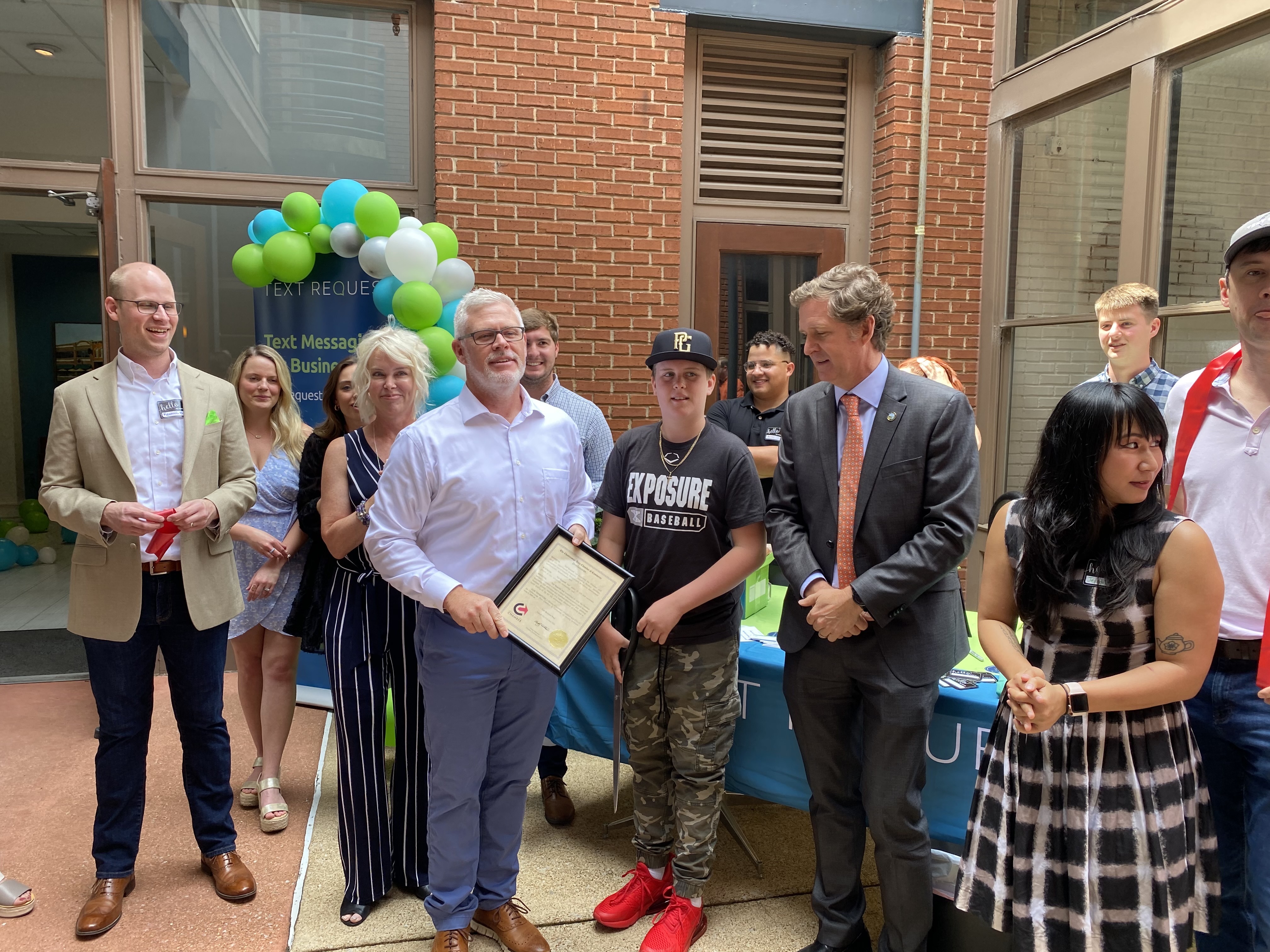Photo contributed by Text Request / Kenneth Burke, Jamey and Brian Elrod and Mayor Tim Kelly celebrate the opening of the new Text Request headquarters.