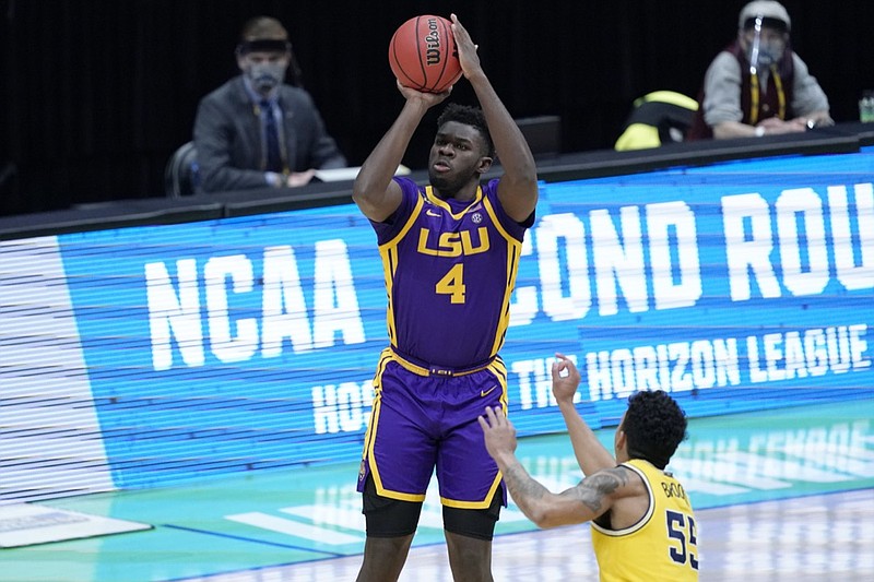 FILE - LSU forward Darius Days (4) shoots over Michigan guard Eli Brooks (55) during the first half of a second-round game in the NCAA men's college basketball tournament at Lucas Oil Stadium in Indianapolis, in this Monday, March 22, 2021, file photo. Forward Darius Days is returning to LSU for his senior season after initially exploring his opportunity to turn pro. Days, who announced his decision during an online talk show appearance in Baton Rouge on Tuesday, June 29, 2021, had previously declared his intention to enter this summer's NBA draft after last season.(AP Photo/AJ Mast, File)