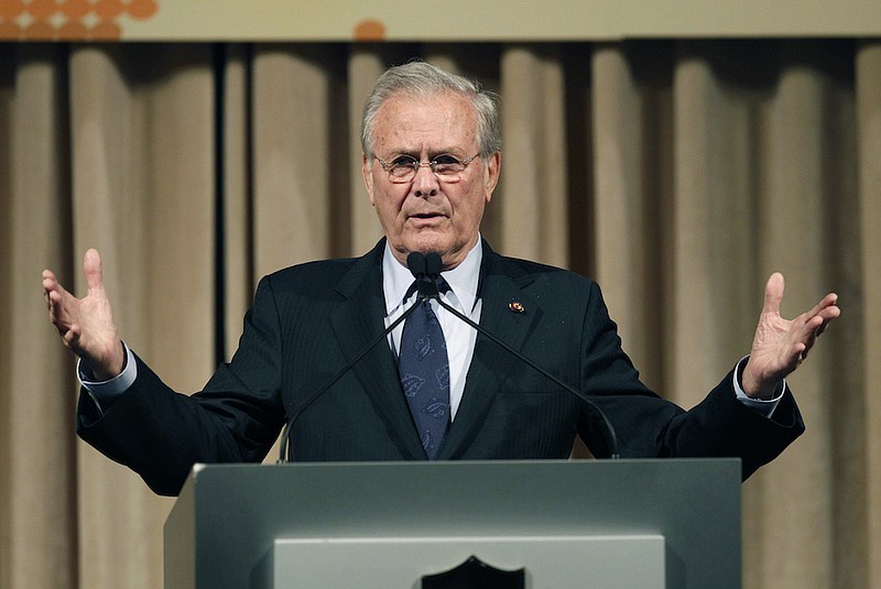 In this Oct. 11, 2011, file photo, former U.S. Secretary of Defense Donald Rumsfeld speaks to politicians and academics during a luncheon on security in rising Asia, in Taipei, Taiwan. The family of Rumsfeld says he has died. He was 88. (AP Photo/Wally Santana, File)