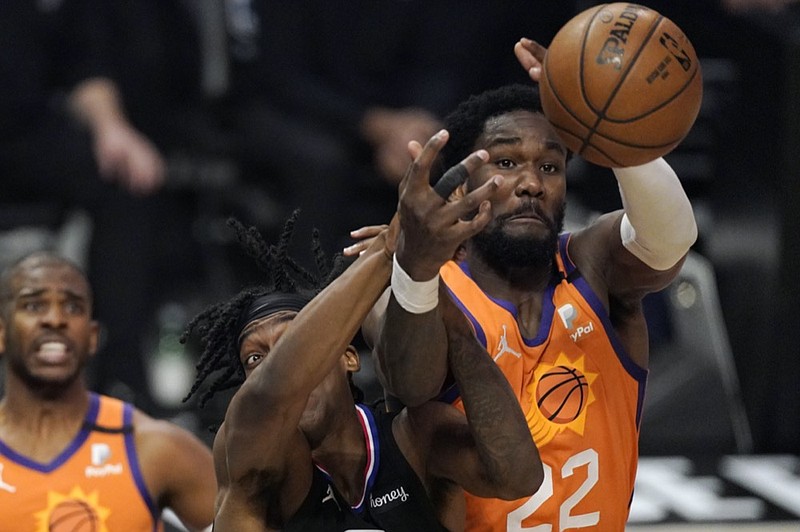 Los Angeles Clippers guard Terance Mann, left, and Phoenix Suns center Deandre Ayton reach for a rebound during the second half in Game 6 of the NBA basketball Western Conference Finals Wednesday, June 30, 2021, in Los Angeles. (AP Photo/Mark J. Terrill)


