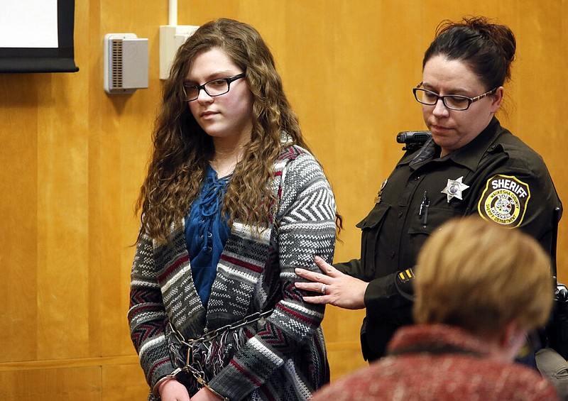 In this Dec. 21, 2017, file photo, Anissa Weier, one of two Wisconsin girls who tried to kill a classmate to win favor with a fictional horror character named Slender Man, is led into Court for her sentencing hearing, in Waukesha, Wis. A Wisconsin judge on Thursday, July 1, 2021, ordered her release after being convicted of the stabbing in 2014. Weier asked Waukesha County Judge Michael Bohren this year to release her from the Winnebago Mental Health Institute, arguing she was no longer a threat to anyone. (Michael Sears/Milwaukee Journal-Sentinel via AP, File)