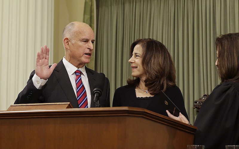 Associated Press File Photo / California Gov. Jerry Brown, left, takes the oath of office for his fourth term as governor of California in 2015, proving the state is one of those in the country with no term limits for its chief executive.