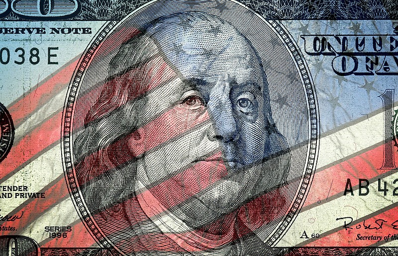 American one hundred dollar bill and American flag. / Photo credit: 