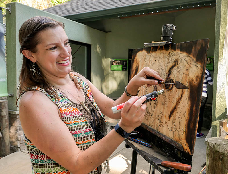 Photo by Mark Gilliland / Hollie Berry does a torch painting.